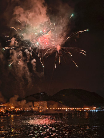 beautiful colorful fireworks in the night sky on the seafront of Alicante spainの写真素材