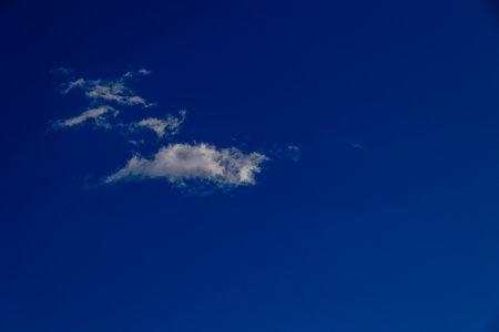 blue sky background with small white cloudの写真素材
