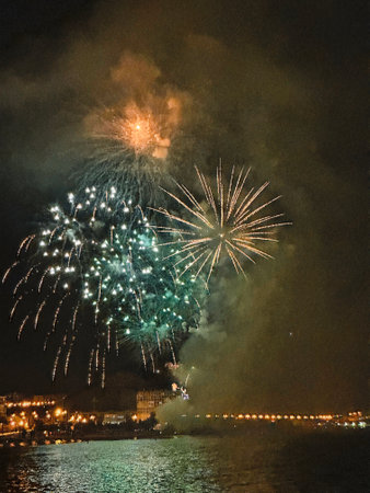 beautiful colorful fireworks in the night sky on the seafront of Alicante spainの写真素材