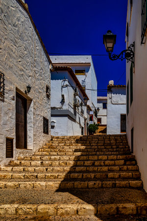 beautiful urban narrow street in the Spanish city of Altea on a summer dayの写真素材