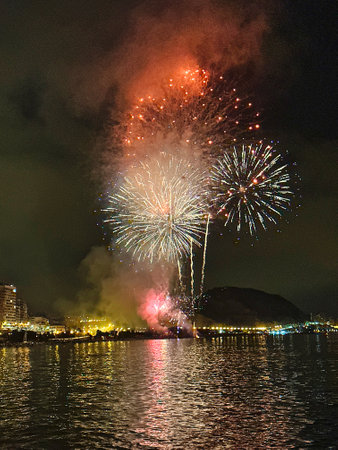beautiful colorful fireworks in the night sky on the seafront of Alicante spainの写真素材