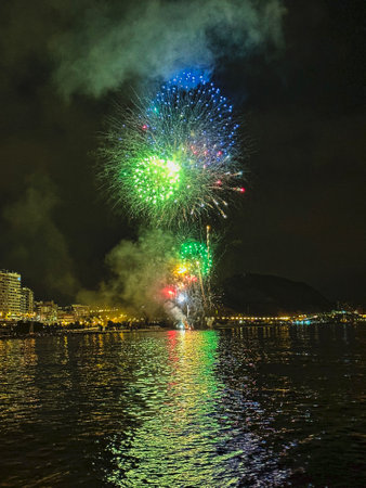 beautiful colorful fireworks in the night sky on the seafront of Alicante spainの写真素材