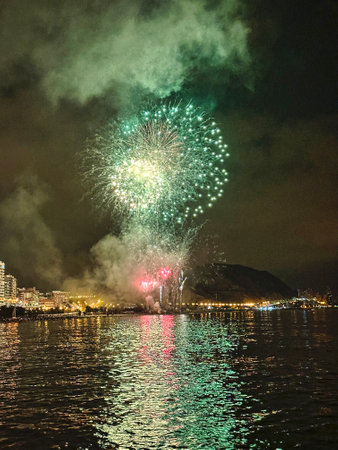 beautiful colorful fireworks in the night sky on the seafront of Alicante spainの写真素材