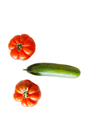 beautiful tomato and green cucumber on a white backgroundの写真素材