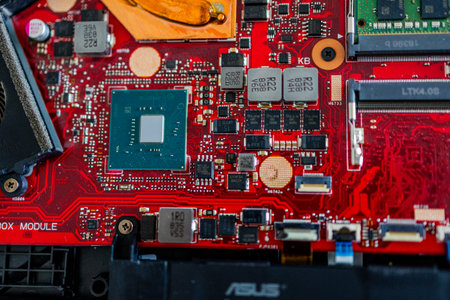 A close up view showcases a motherboard with intricate circuit patterns, RAM modules, and various electronic componentsの写真素材
