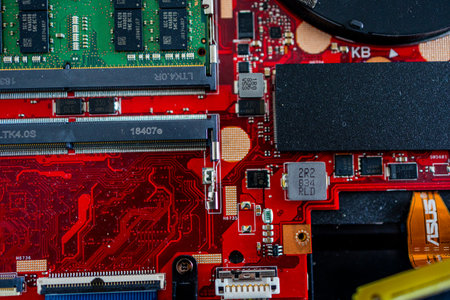 A close up view showcases a motherboard with intricate circuit patterns, RAM modules, and various electronic componentsの写真素材