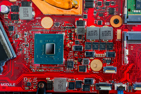 A close up view showcases a motherboard with intricate circuit patterns, RAM modules, and various electronic componentsの写真素材