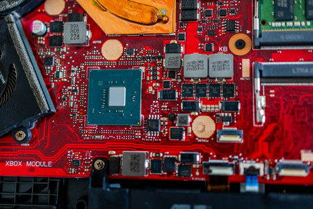 A close up view showcases a motherboard with intricate circuit patterns, RAM modules, and various electronic componentsの写真素材