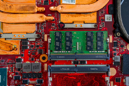 A close up view showcases a motherboard with intricate circuit patterns, RAM modules, and various electronic componentsの写真素材