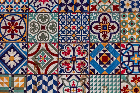 A collection of decorative ceramic tiles displays an array of intricate patterns and vibrant colors, including blues, reds, and greensの写真素材