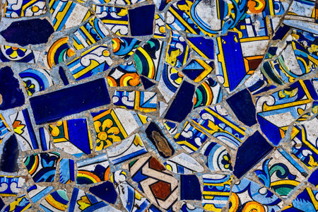 A collection of decorative ceramic tiles displays an array of intricate patterns and vibrant colors, including blues, reds, and greensの写真素材