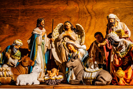 A detailed nativity scene showcases a collection of figures, including shepherds, angels, and the three Magi, gathered around baby Jesus in a mangerの写真素材