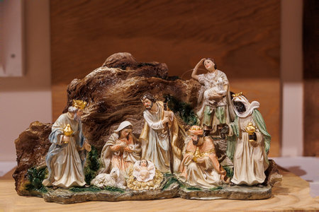 A detailed nativity scene showcases a collection of figures, including shepherds, angels, and the three Magi, gathered around baby Jesus in a mangerの写真素材