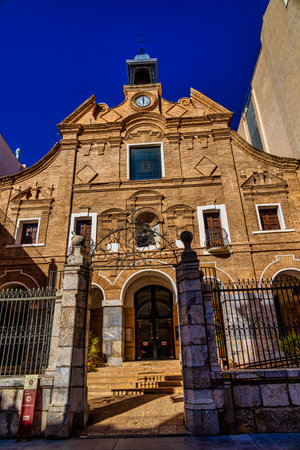 A grand historic building is centered within a lively square.の写真素材