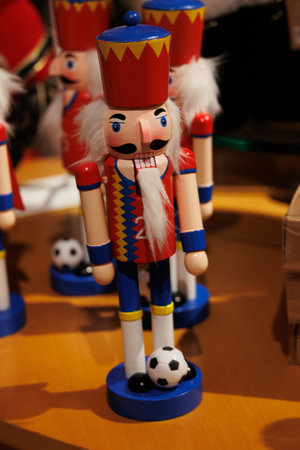 A wooden nutcracker soldier wearing a regal crown and a red cape is prominently displayed.の写真素材