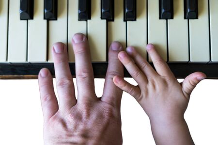 Top view of the hand of a small child playing on the pianoの写真素材