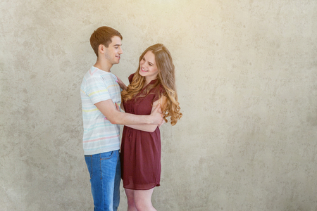 Couple in love having nice time together. Young happy woman hugging boyfriend, white background. Students, bride, groom, engagement, relationship, aspirations, supporting relying concept Bannerの写真素材