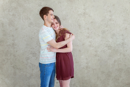 Couple in love having nice time together. Young happy woman hugging boyfriend, white background. Students, bride, groom, engagement, relationship, aspirations, supporting relying concept Bannerの写真素材