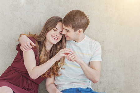 Couple in love having nice time together. Young happy woman hugging boyfriend, white background. Students, bride, groom, engagement, relationship, aspirations, supporting relying concept Bannerの写真素材