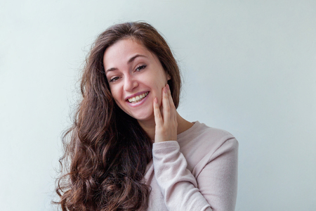 Happy girl smiling. Beauty portrait young happy positive laughing brunette woman on white background isolated. European woman. Positive human emotion facial expression body languageの写真素材