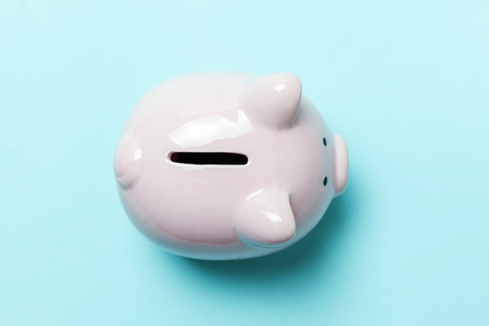 Saving investment budget wealth retirement financial money banking concept. Pink piggy bank isolated on blue pastel colourful trendy background. Flat lay top view copy spaceの写真素材