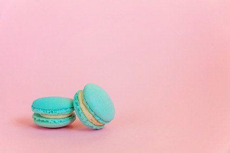 Sweet almond colorful unicorn blue macaron or macaroon dessert cake isolated on trendy pink pastel...