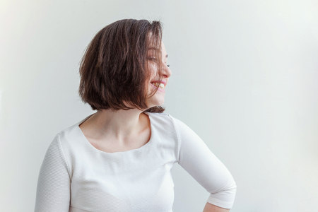 Happy girl smiling. Beauty portrait young happy positive laughing brunette woman on white background isolated. European woman. Positive human emotion facial expression body languageの写真素材