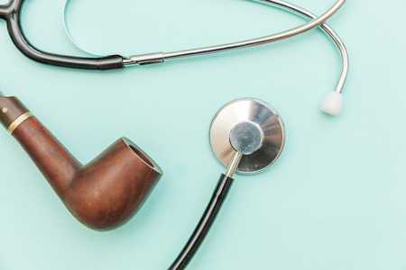 Man health care concept. Simply minimal design with medicine equipment stethoscope or phonendoscope smoking pipe isolated on trendy pastel blue background. Doctor urologistの写真素材