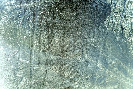 christmass background snow frosty pattern on winter window