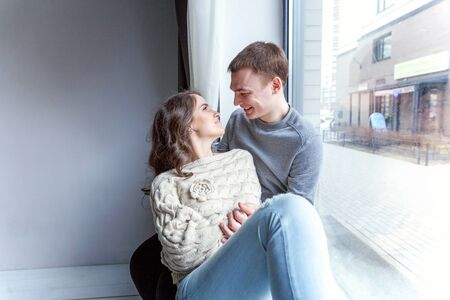 Romantic sexy couple in love having nice time together. Young woman hugging boyfriend, white...