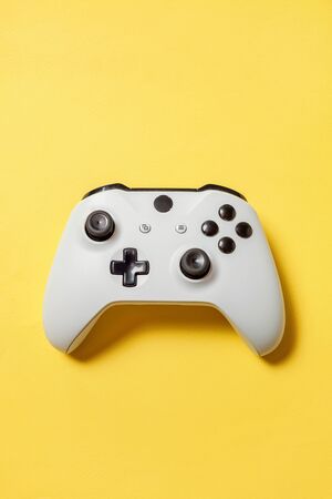 White joystick gamepad, game console on yellow colourful trendy modern fashion pin-up background....