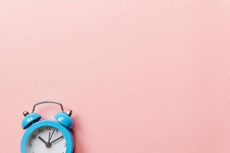 Ringing twin bell vintage classic alarm clock Isolated on pink pastel colorful trendy background....