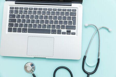 Stethoscope keyboard laptop computer isolated on blue background. Modern medical Information...