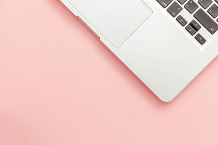 Keyboard laptop computer isolated on pink pastel desk background. Modern Information technology and...