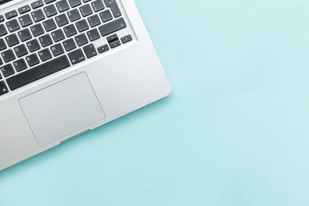 Keyboard laptop computer isolated on blue pastel desk background. Modern Information technology and...