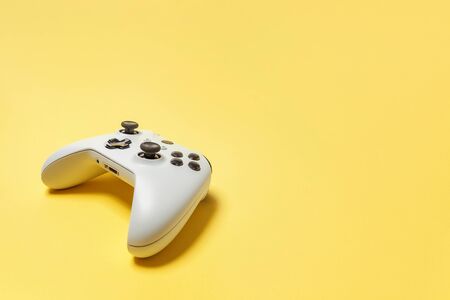 White joystick gamepad, game console on yellow colourful trendy modern fashion pin-up background....