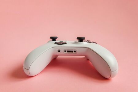 Photo for White joystick gamepad, game console on pastel pink colourful trendy modern pin-up background. Computer gaming competition videogame control confrontation concept. Cyberspace symbol - Royalty Free Image