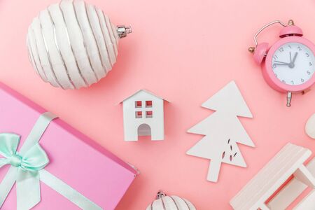 Simply minimal composition winter objects ornament sled fir tree ball gift box isolated pink pastel background. Christmas New Year december time for celebration concept. Flat lay top view copy spaceの写真素材