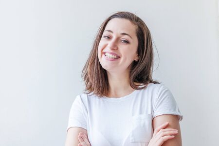 Happy girl smiling. Beauty portrait young happy positive laughing brunette woman on white background isolated. European woman. Positive human emotion facial expression body languageの写真素材