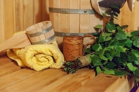 Interior details Finnish sauna steam room with traditional sauna accessories basin birch broom scoop...