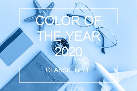 Minimal simple flat lay with plane passport sunglasses globe gold credit card and shell colored in trendy color of yearの写真素材