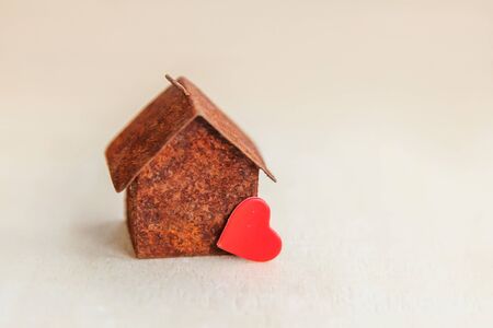 Miniature toy model house with red heart on wooden backdrop. Eco Village, abstract environmental background. Real estate mortgage property sweet dream home ecology conceptの写真素材