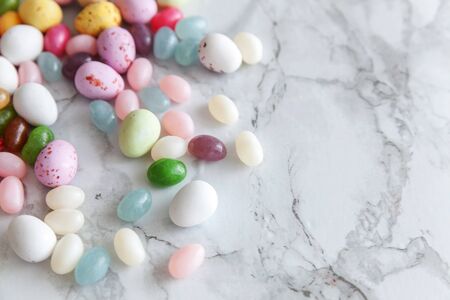 Happy Easter concept. Preparation for holiday. Easter candy chocolate eggs and jellybean sweets on...