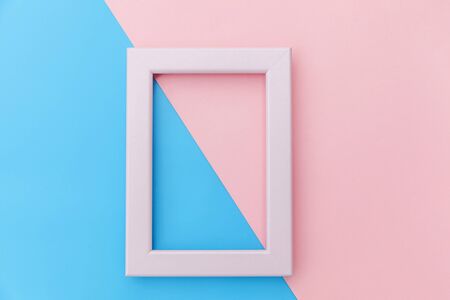Simply design with empty pink frame isolated on pink and blue pastel colorful background. Top view, flat lay, copy space, mock up. Minimal conceptの写真素材