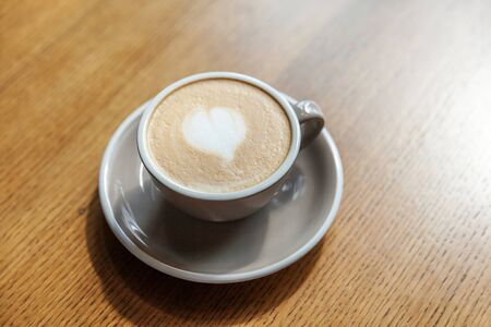 Coffee cup fresh cream organic cappuccino on table in cafe. Latte macchiato drink in glass close up. Wake up, morning addiction conceptの写真素材