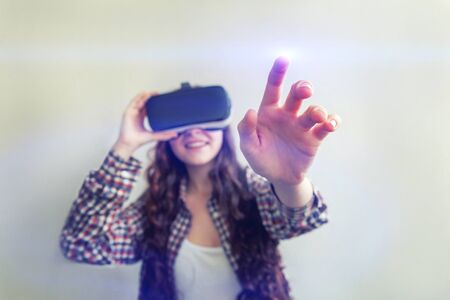 Smile young woman wearing using virtual reality VR glasses helmet headset on white background....