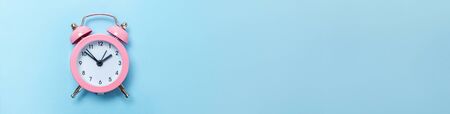 Simply minimal design ringing twin bell classic alarm clock Isolated on blue pastel background. Rest...