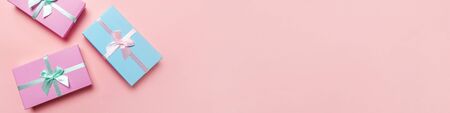 Christmas New Year birthday valentine celebration present romantic concept. Simply minimal design blue pink gift box isolated on pink pastel colorful background. Flat lay top view copy space bannerの写真素材