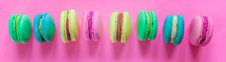 Sweet almond colorful pink blue yellow green macaron or macaroon dessert cake isolated on trendy...