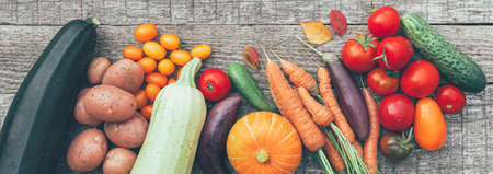Assortment different fresh organic vegetables on country style wooden background. Healthy food vegan...